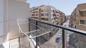 A balcony with a metal drying rack, overlooking a street with parked cars and multi-story buildings. - Apartment 'Edimar' with Balcony and Air Conditioning (Benidorm)