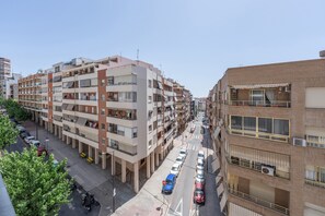 A multi-story residential building with balconies, a parking lot, and a clear sky. - Apartment 'Edimar' with Balcony and Air Conditioning (Benidorm)
