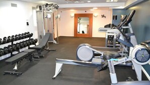 A gym with exercise equipment including dumbbells, a bench, and cardio machines. - Student Only St Andrew Street (Aberdeen)
