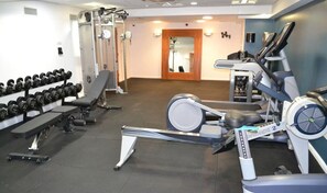 A gym with exercise equipment including dumbbells, a bench, and cardio machines. - Student Only St Andrew Street (Aberdeen)