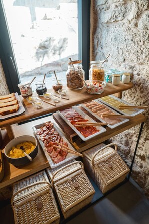 A buffet table with various food items and condiments.