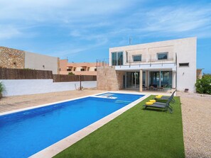A modern two-story building with a swimming pool and outdoor seating area. - Villa Brisa by Interhome (Colònia Sant Pere)
