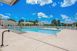 A swimming pool with lounge chairs and a white fence. - The Victorian Golf Tee at Legends (Myrtle Beach)
