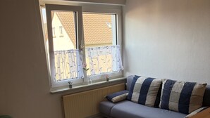 A room with a window, a radiator, a sofa, and a bed. - Holiday Home Milan with Private Terrace and Garden (Holzminden)