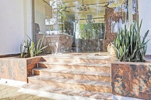 A set of marble stairs leading to a building entrance with a glass door. - Collection O Arvind Marg Pachamarhi (Pachmarhi)