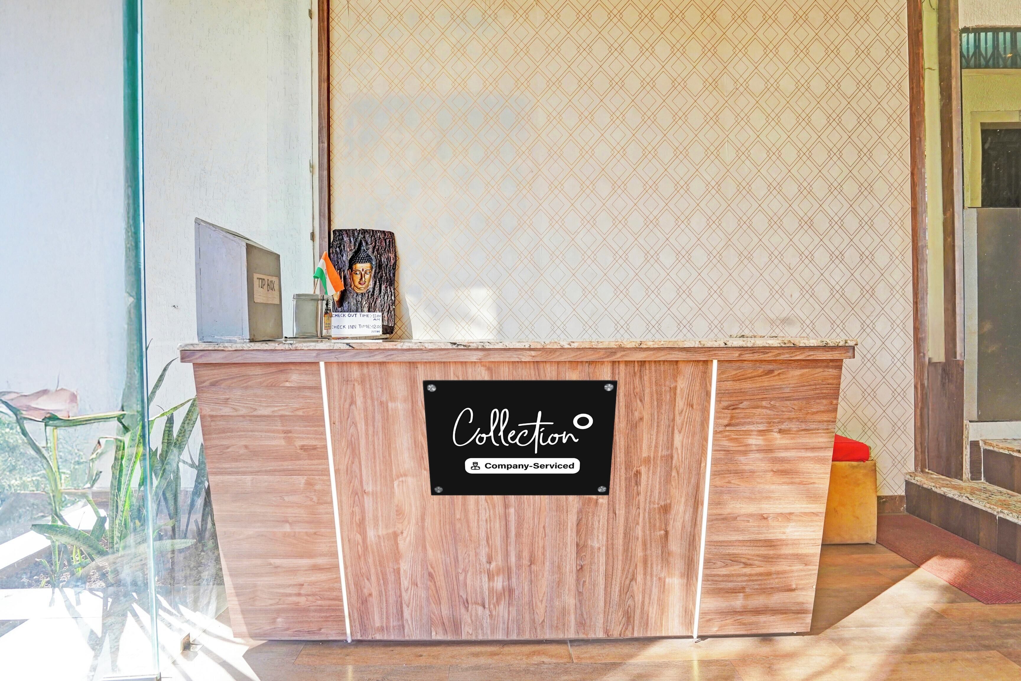 A wooden reception desk with a sign indicating it is company-serviced.