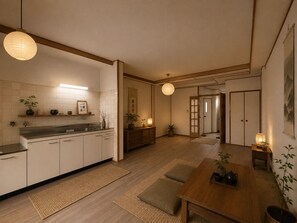 A modern kitchen with a wooden countertop, a sink, and a dining area with a table and chairs. - Spacious 4-Bedroom, 2-Bathroom House Near Kyoto: Nintendo Museum & Torii Gates (Uji)