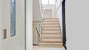 A staircase with a handrail and a window at the top. - Super Collection O Baner (Pune)