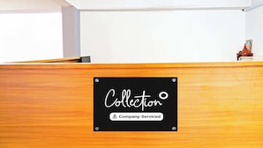 A reception desk with a sign that reads 'Collection' and 'Company-Serviced.' - Super Collection O Baner (Pune)