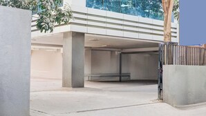 A parking garage with concrete pillars and a metal gate. - Super Collection O Pashan-Sus Road Baner (Pune)