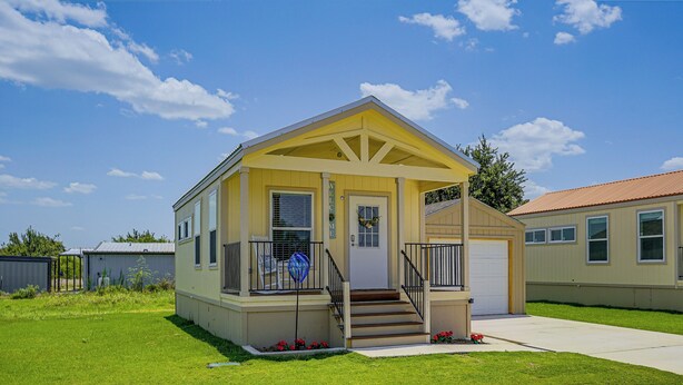A single-story house with a porch, a front door, and a small set of stairs leading to the entrance. - Tiny Home Retreat Close to Lake Granbury (Granbury)
