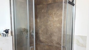 A glass-enclosed shower stall with a showerhead and a handheld shower attachment. - "Matilda Airport BG-4 -minute drive from BGY" (Bergamo)