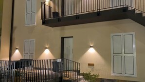 A two-story building with a balcony on the upper floor, a door on the ground floor, and a small outdoor seating area. - "Matilda Airport BG-4 -minute drive from BGY" (Bergamo)