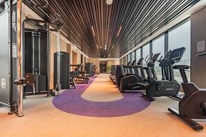 A gym with treadmills, weight machines, and a purple carpeted floor. - Just a Stone Throw from the Public Park and a Short Drive from Butterfly Garden (Dubai)