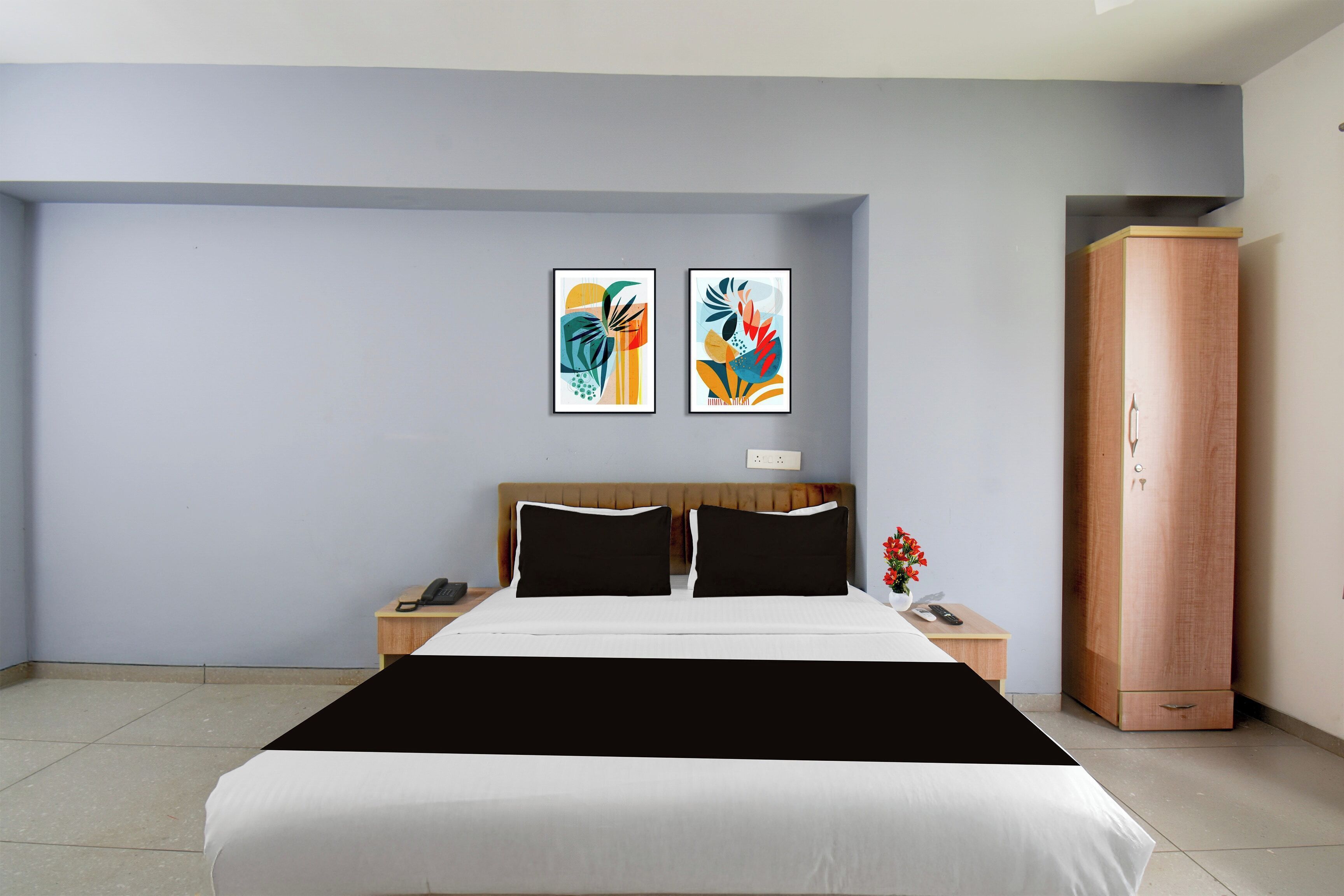 Un dormitorio moderno con cama, mesitas de noche, un armario y arte abstracto en la pared.