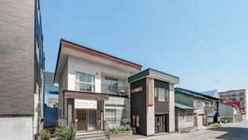A modern building with a storefront labeled 'Harunoya Otamu.'