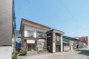 A modern building with a storefront labeled 'Harunoya Otamu.' - HARMONY OTARU (Otaru)