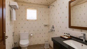 A bathroom with a toilet, sink, and shower.