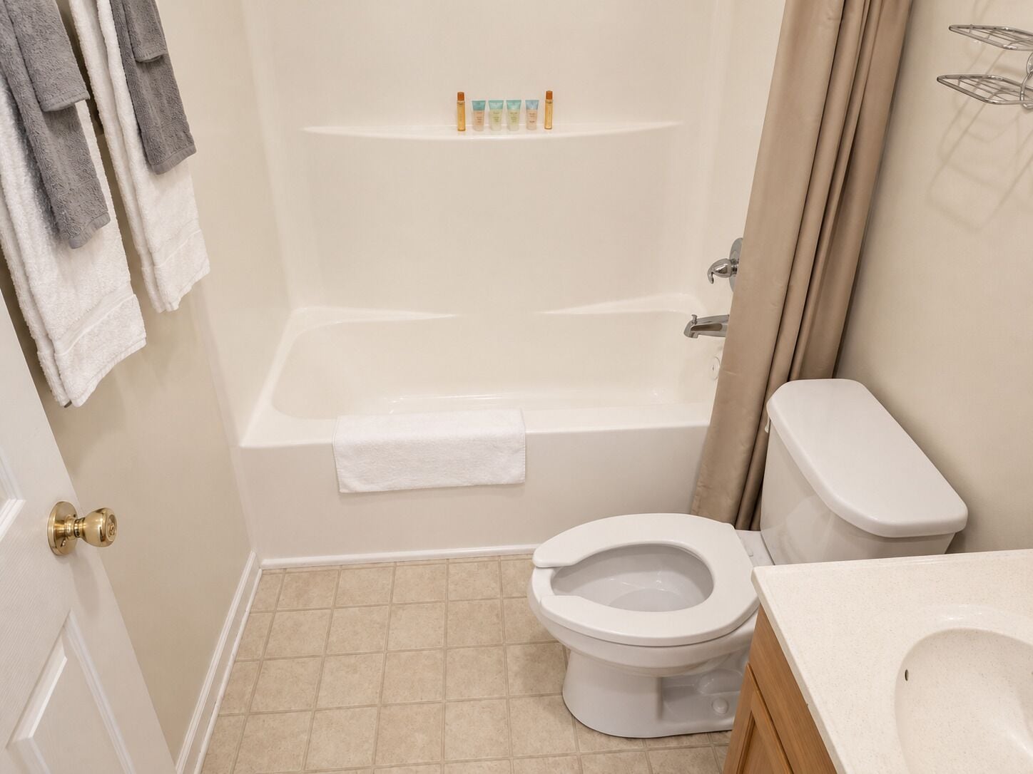 A bathroom with a bathtub, toilet, and sink.