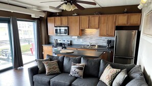 A modern kitchen with a built-in microwave, stove, and refrigerator. - Waterfront patio 2 bedroom condo (Sandusky)