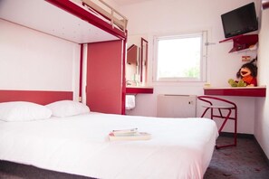 A single bed with pillows, a desk with a chair, a television, and a window. - Class'eco Charleroi (Gosselies)