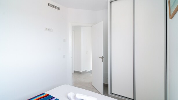 A hotel room with a bed, a wardrobe, and a door leading to another room. - Villa Casa Mezcal by Casasol (Nerja)