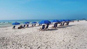 A beach with rows of blue umbrellas and beach chairs. - Summit 908/908A Luxury Gulf-View Escape | TOPS'L Resort | Walk to the Beach (Miramar Beach)