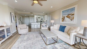 A spacious living room with a white sofa, a coffee table, and a patterned rug. - Summit 908 – Spacious Gulf-View Retreat at TOPS'L (Miramar Beach)