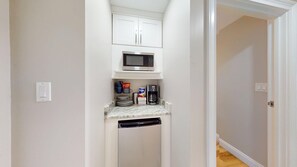 A compact kitchen with a microwave, coffee maker, and storage cabinets. - Summit 0908A Romantic Gulf-View Studio at TOPS'L Resort (Miramar Beach)