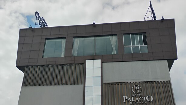 A hotel with a modern design, featuring a prominent 'Palacio Regency' sign.