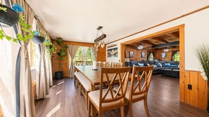 A wooden interior with a dining area, a sofa, and a ceiling fan. - Riverfront Log Home - 28 Acres - Fire Pit (Warner)
