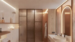Un baño moderno con un espejo grande, dos lavamanos, un inodoro y una zona de ducha.