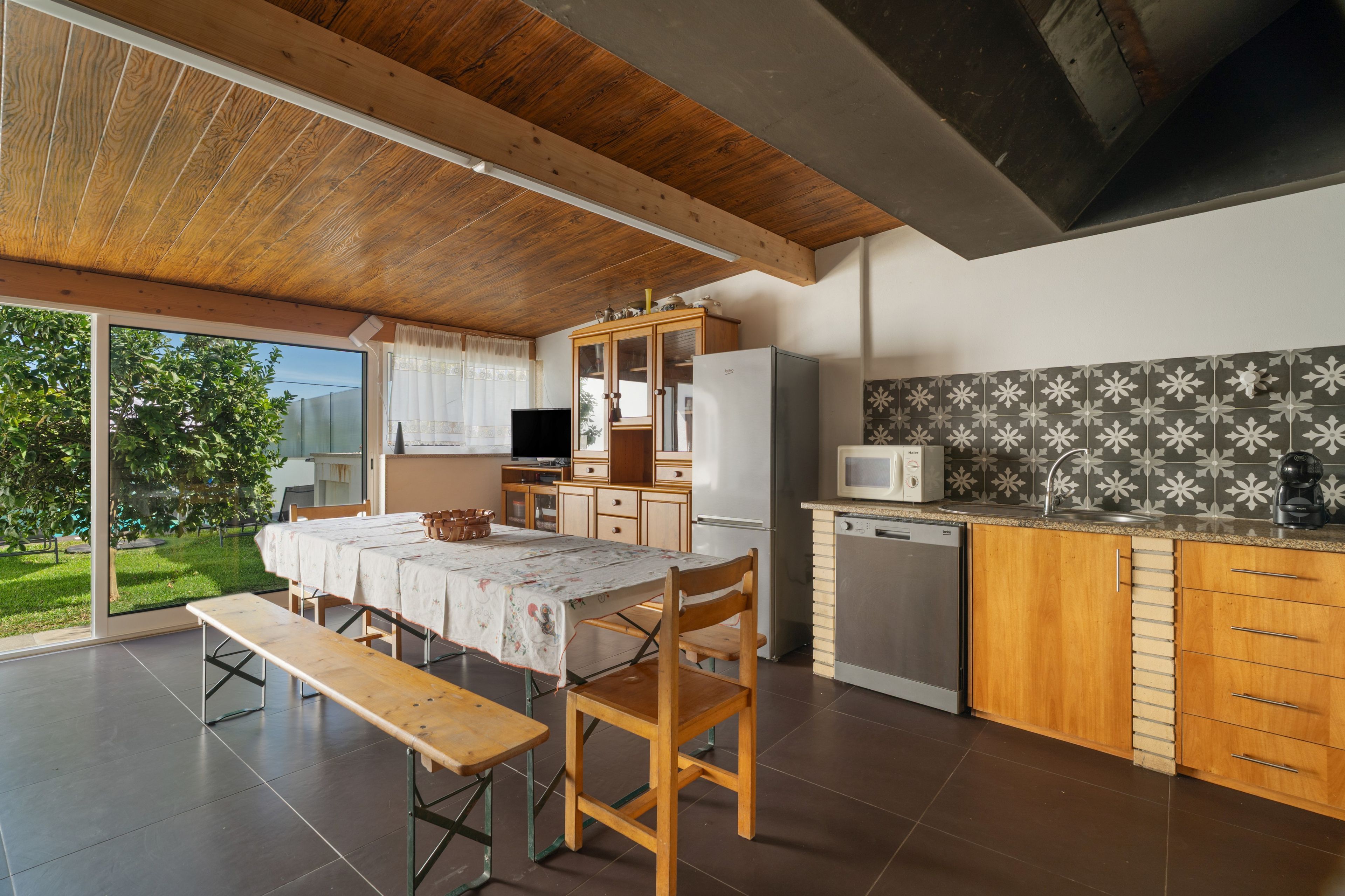 A modern kitchen with wooden cabinets, a built-in microwave, and a dishwasher.