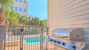 A backyard with a pool, a grill, and a gated entrance. - Luxury 6BR, Private Pool, Beach Access, Sleeps 20 (Destin)