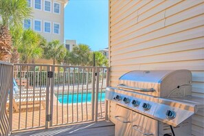 A backyard with a pool, a grill, and a gated entrance. - Luxury 6BR, Private Pool, Beach Access, Sleeps 20 (Destin)
