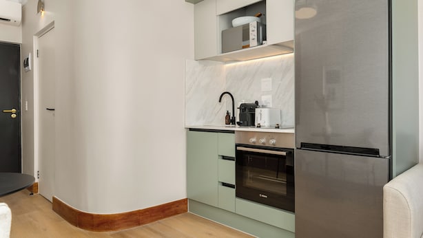 A modern kitchen with a built-in oven, a stainless steel refrigerator, and a microwave. - Charlie and the Chairman | Contemporary Stay (Cape Town)