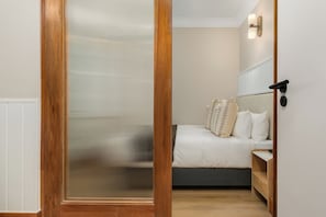 Ein Schlafzimmer mit Bett, Nachttisch und einem Holzschrank.