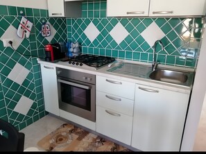 Private kitchen - Holiday home 100 m from the beach with private terrace, balcony, and air conditioning (Lu Bagnu)