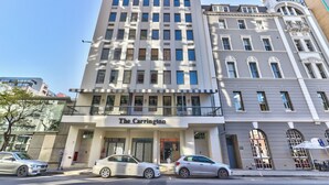 Un edificio de varios pisos con una entrada destacada que dice 'The Carrington'.