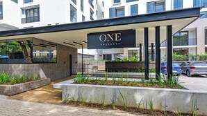 A modern building with a sign reading "ONE ROSEBANK". - One Rosebank | Elevated Urban Comfort (Johannesburg)
