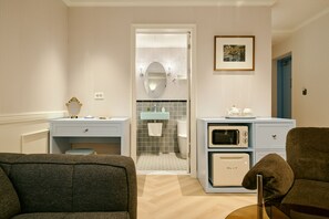 A modern bathroom with a vanity, a toilet, and a shower area.