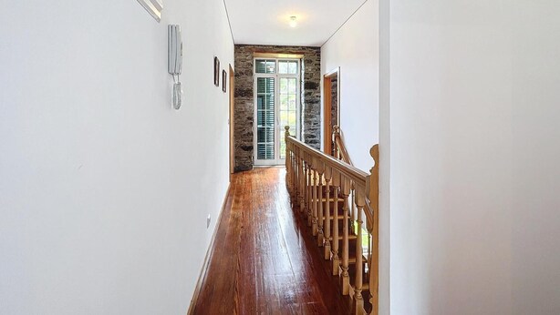 A hallway with a wooden staircase, a stone wall, and a door with shutters. - Villa 'Quinta Do Serrado' with Sea View, Private Garden and Wi-Fi (Ribeira da Janela)