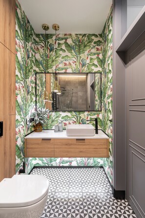 A bathroom with a modern sink, a toilet, and a shower area. - Helska 11 - Apartamenty blisko plaży  (Sopot)