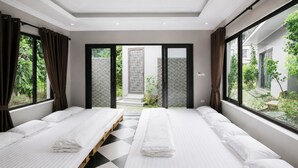 A hotel room with two beds, a checkered floor, and large windows with curtains.