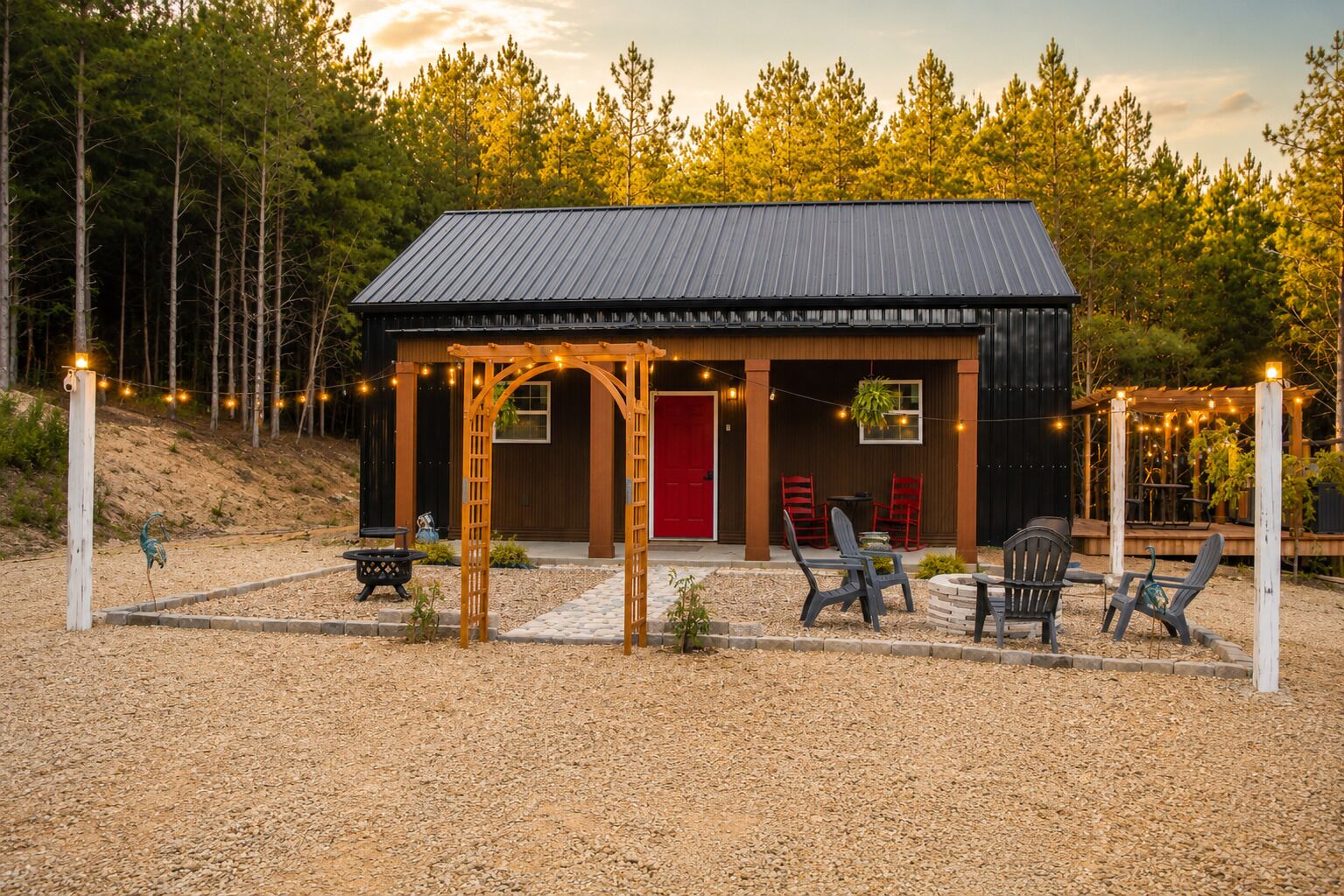 A rustic cabin with a metal roof, a red door, and outdoor seating.