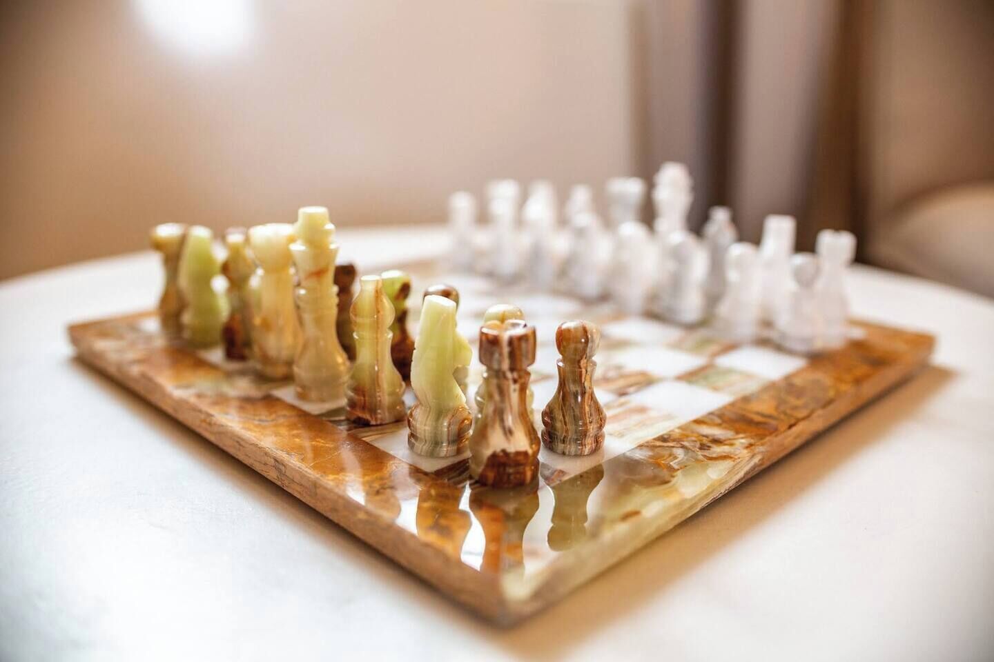 A chessboard with pieces on a wooden surface.