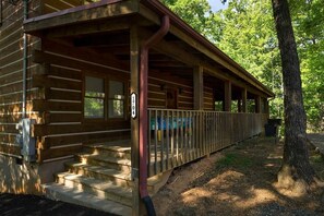 A wooden cabin with a covered porch and a number '1704' sign. - Sugar Bear Smoky Mountain Cabin Getaway (Sevier County)