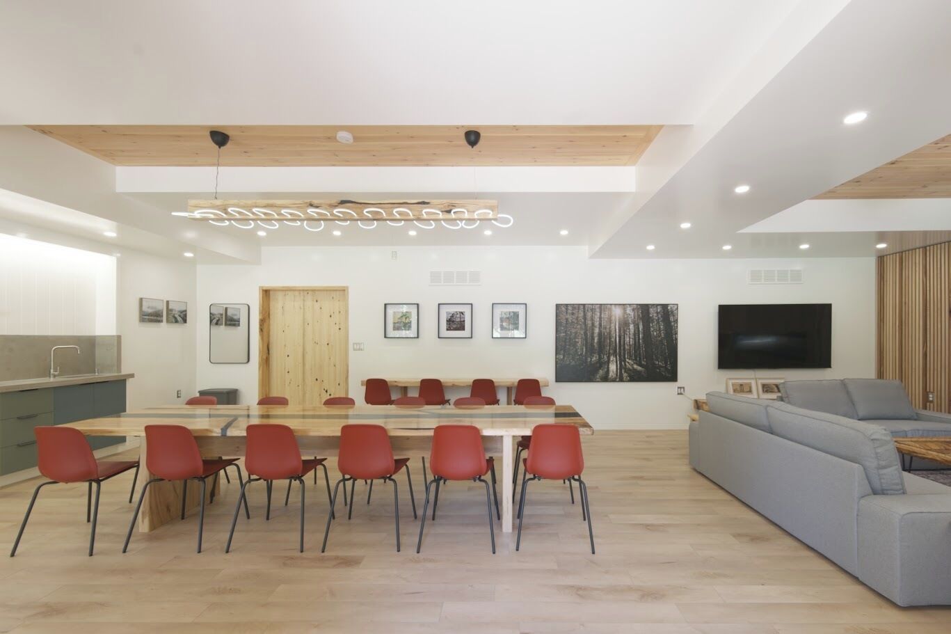 A modern interior with a dining area, kitchen, and living space.