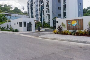 A modern building with a sign reading 'SOL HARBOR'. - Solèa 6th-Floor High-Rise Studio | Panoramic Ocean Views & Walk to Town (Ocho Rios)