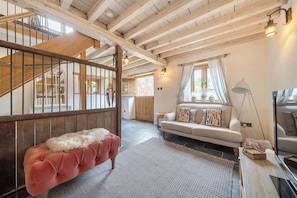 A cozy living room with a sofa, a bench, and a staircase. - 1 Bed Barn - Sleeps 2 - Pool - Garden - Bbq (Taunton)